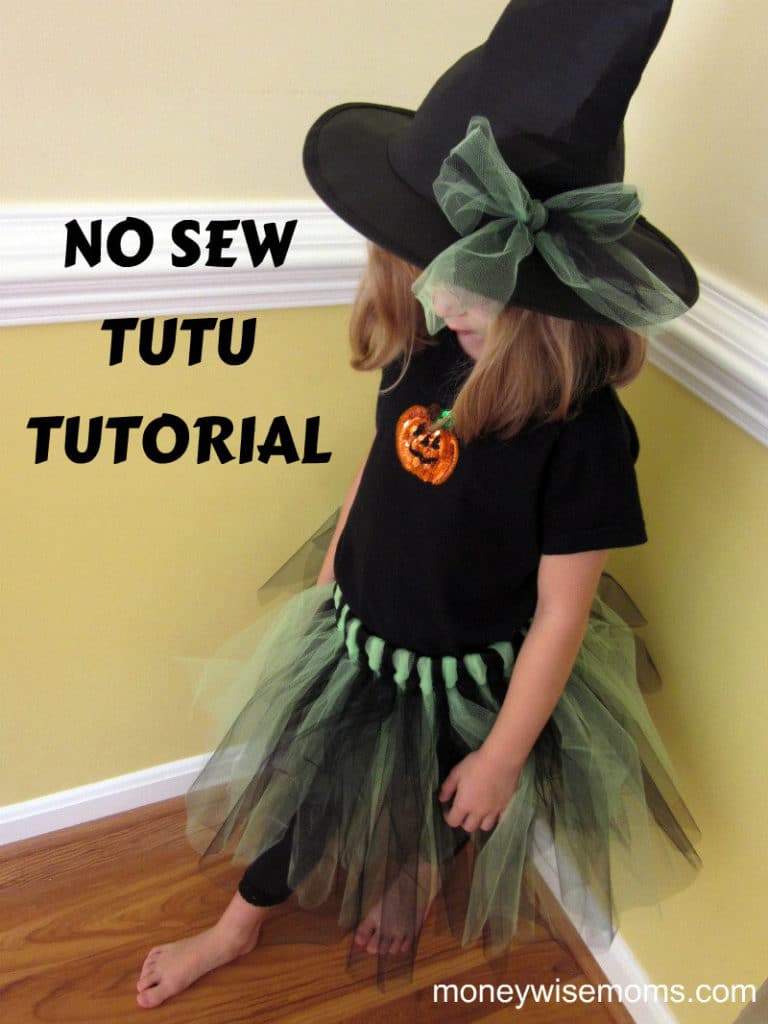 Small girl wearing black tee and green witch tutu