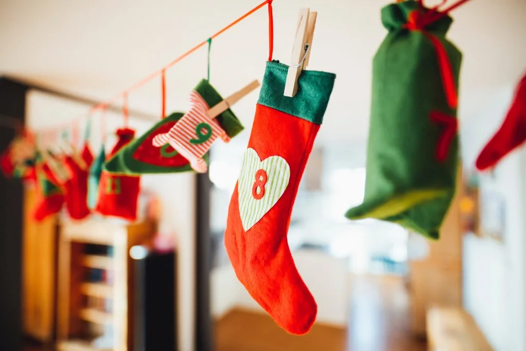 Red and green stockings hanging from ribbon