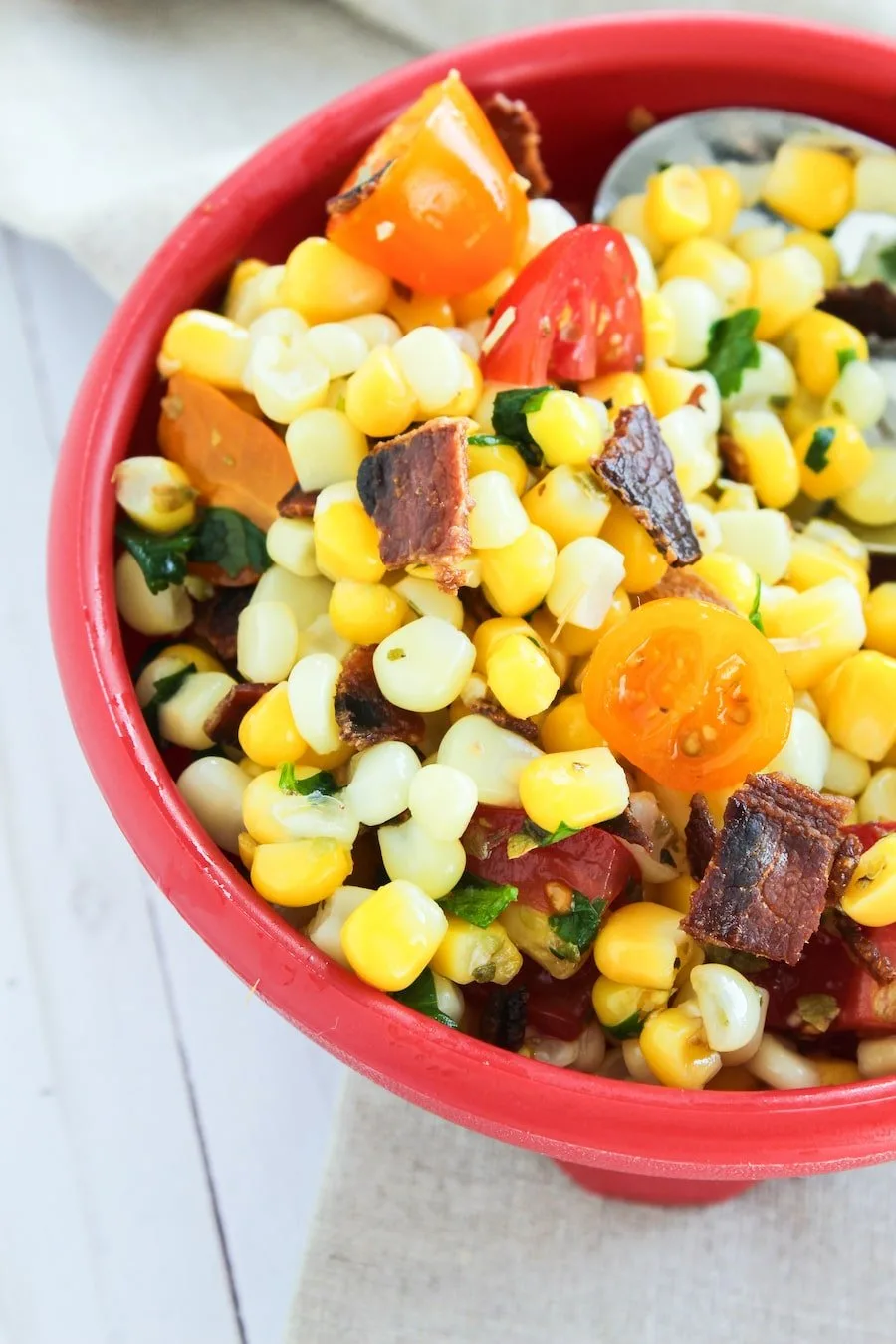 Looking for a new way to serve up some vegetable side dishes? This delicious corn salad with bacon is quick, easy, and delicious. The whole family will love this easy vegetable salad. It's a great picnic recipe as well. 