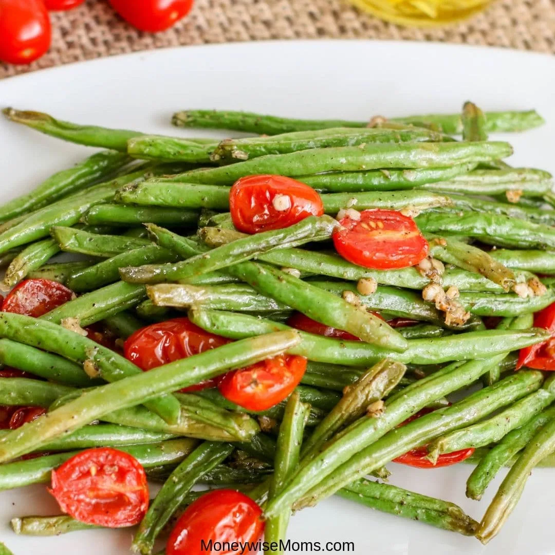 Easy vegetable side dishes that are packed with flavor are my favorite. This garlic green bean recipe with tomatoes is so simple and flavorful. The whole family will love it! 