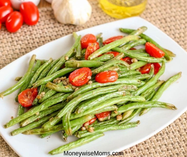 Easy vegetable side dishes that are packed with flavor are my favorite. This garlic green bean recipe with tomatoes is so simple and flavorful. The whole family will love it! 