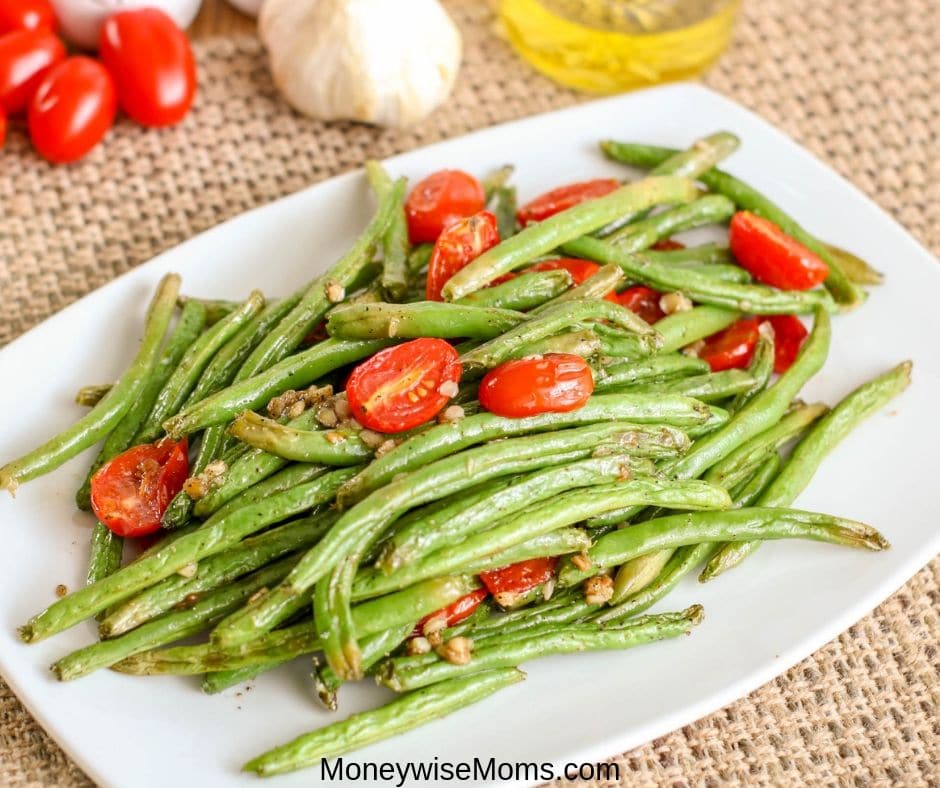 Easy vegetable side dishes that are packed with flavor are my favorite. This garlic green bean recipe with tomatoes is so simple and flavorful. The whole family will love it! 