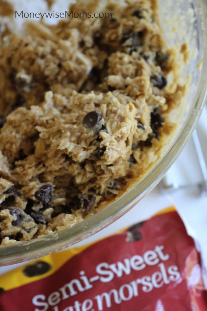 Mixing chocolate chips into oatmeal cookie dough