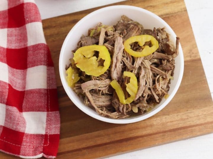 This Italian beef recipe is so easy and delicious. Now that we're back to school we need dinner recipes that require zero fuss! Crockpot dinner recipes are always a winner in my book. Everything goes in and dinner comes out. Not to mention the leftovers are great for lunches in sandwiches or wraps. 