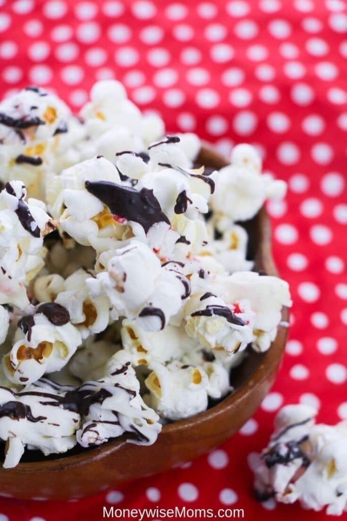 Making peppermint popcorn bark is quick and easy. It's a family favorite holiday recipe and makes a great gift for teachers, friends, and neighbors. Chocolate covered popcorn is a great sweet treat that you can make anytime! 