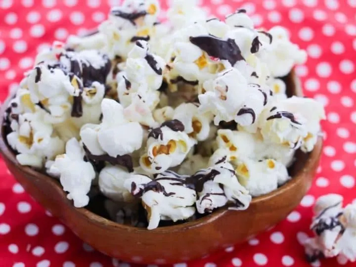 Making peppermint popcorn bark is quick and easy. It's a family favorite holiday recipe and makes a great gift for teachers, friends, and neighbors. Chocolate covered popcorn is a great sweet treat that you can make anytime!