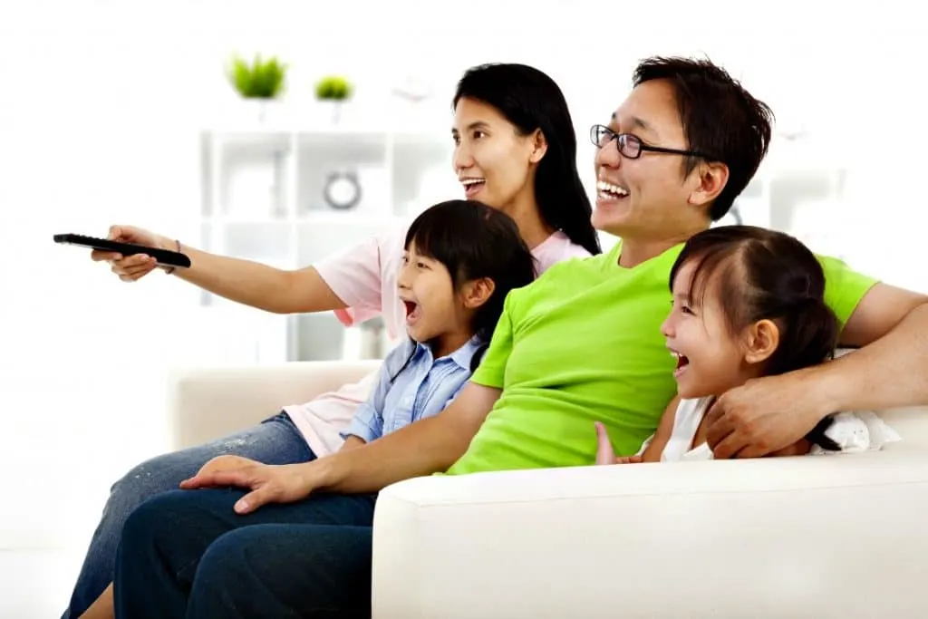 family watching TV together - family movie night ideas