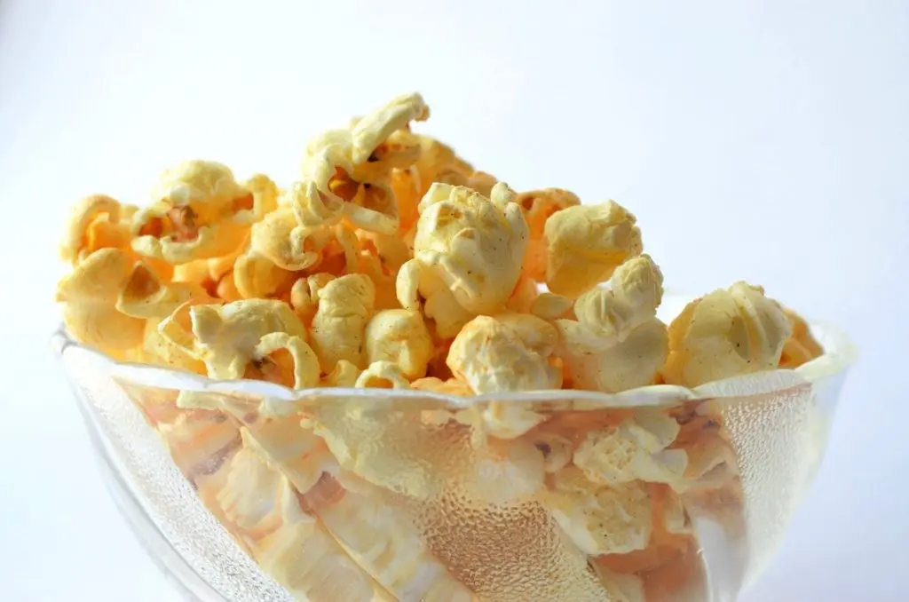100 Popcorn Topping Ideas - spiced popcorn in glass bowl