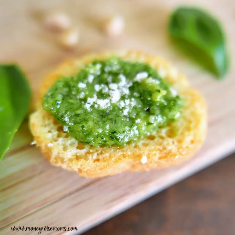 A look at the finished homemade basil pesto on a cracker ready to be enjoyed. 