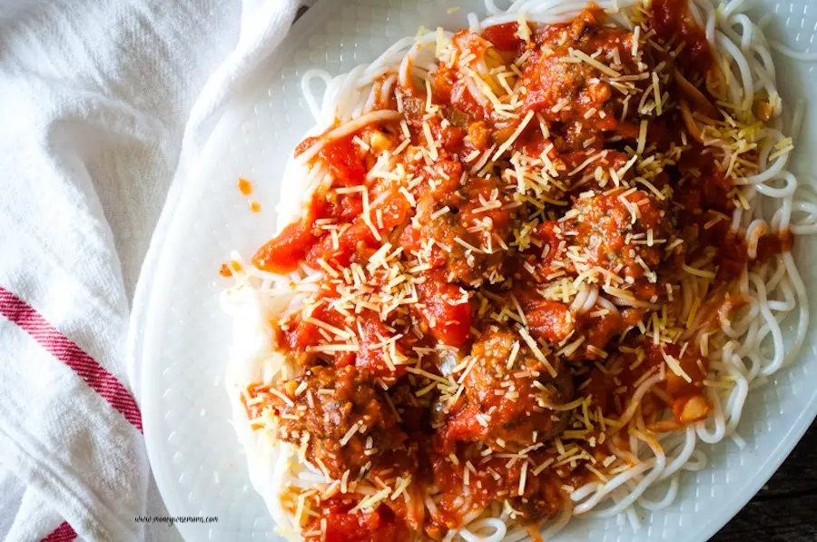 A top down look at a platter full of spaghetti with baked ground turkey meatballs