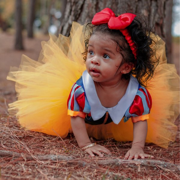 Baby Girl in Tutu Dress Crawling Near Tree