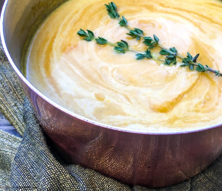 Featured image of a pot of the finished ginger carrot soup recipe.