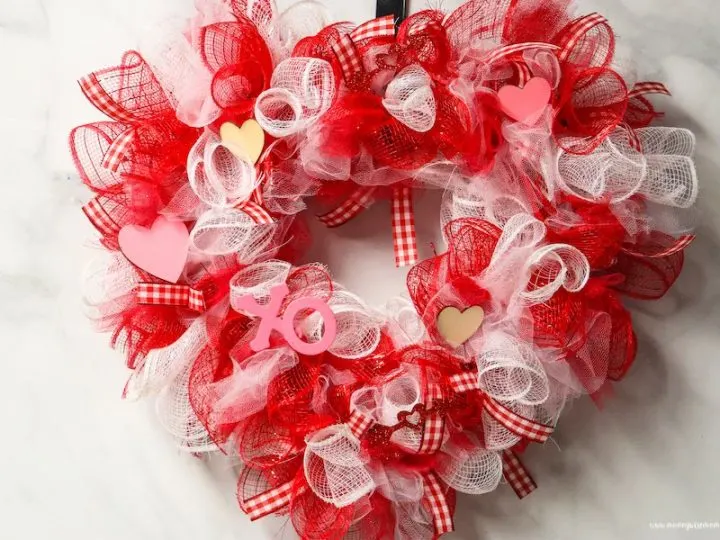 Featured image showing the finished dollar tree valentine wreath ready to hang up or share!