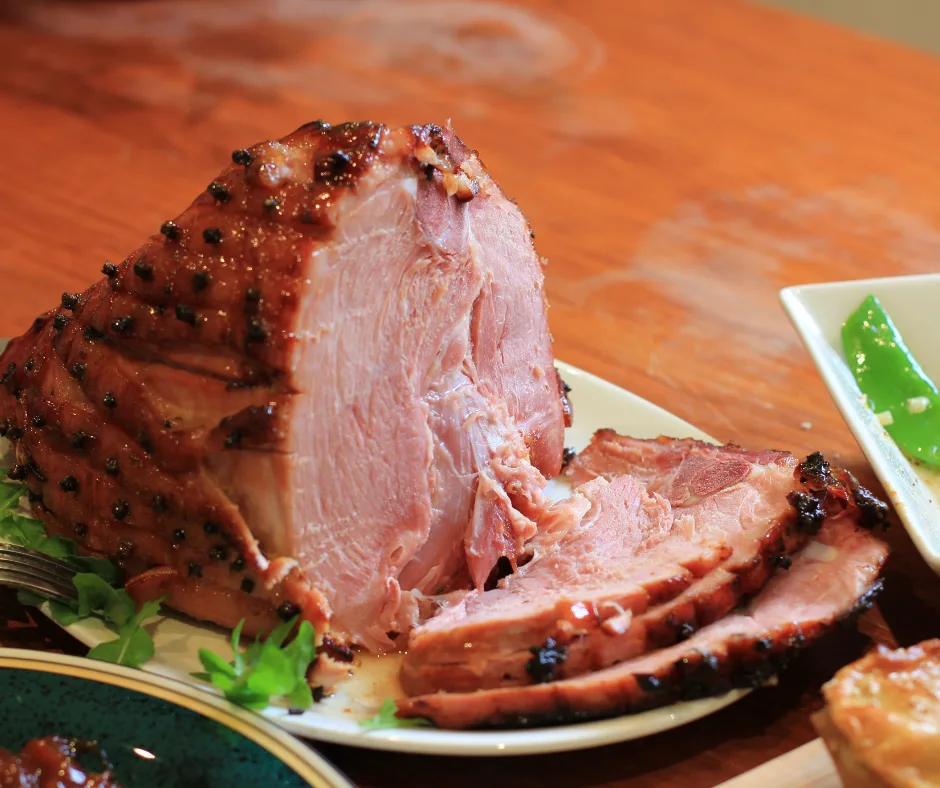 A ham sliced on the cutting board ready to serve. 