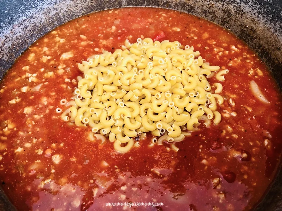 tomato and macaroni being added. 