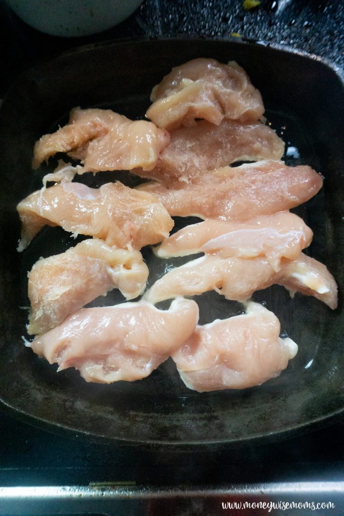 raw chicken in a skillet. 