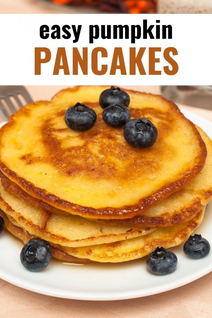 stack of pumpkin pancakes with blueberries on white plate