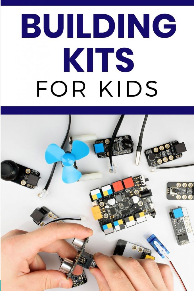 Building kits for kids - hands working with robotic kit components