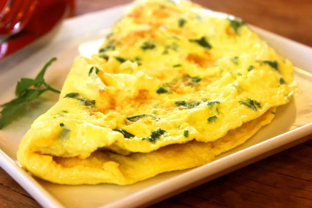 egg and chive omelet on white square dish