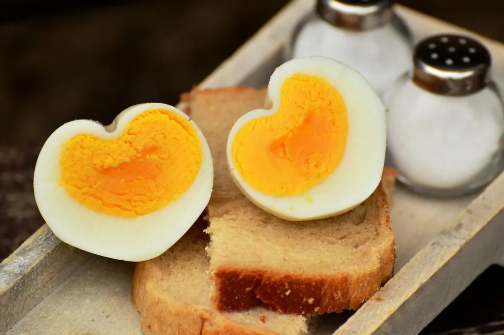 Heart shaped hard boiled eggs on bread