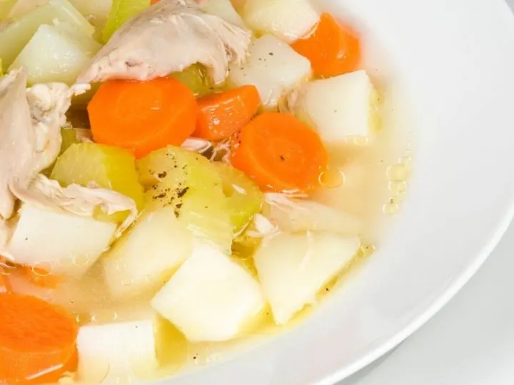 White bowl of chicken potato soup