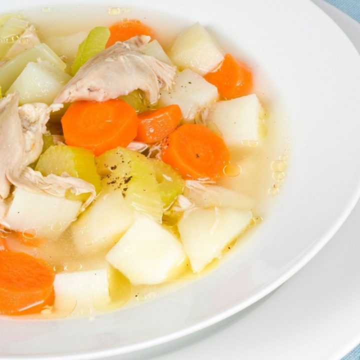 White bowl of chicken potato soup