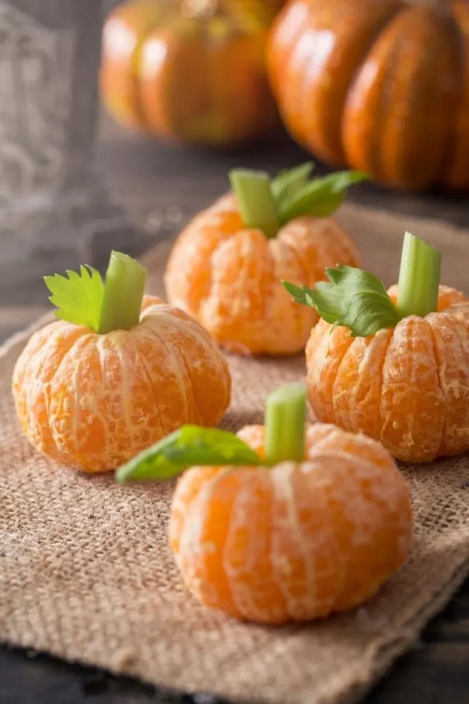 Mandarin oranges turned into pumpkins with celery stems - Halloween movies animated for kids