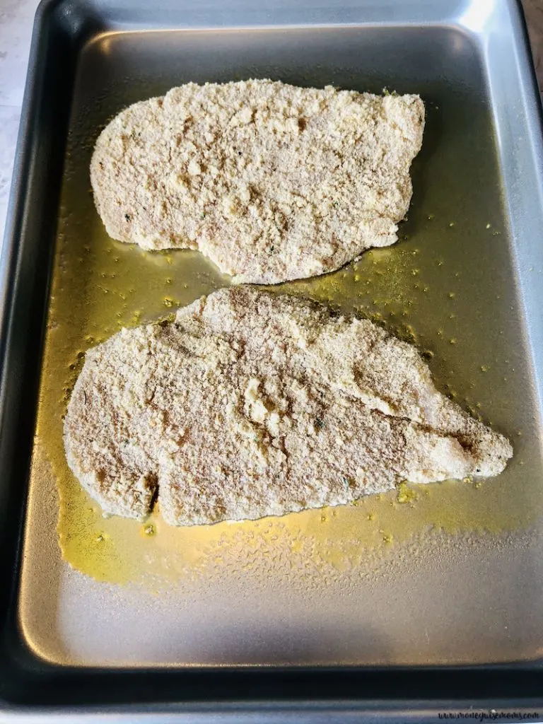 Chicken on baking sheet ready to be placed into the oven. 