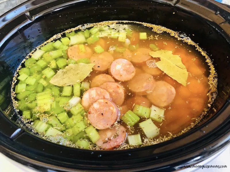 sausage and veggies added to the broth in the crockpot.