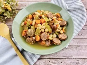 Featured image showing a bowl full of the finished sausage and bean slow cooker soup.