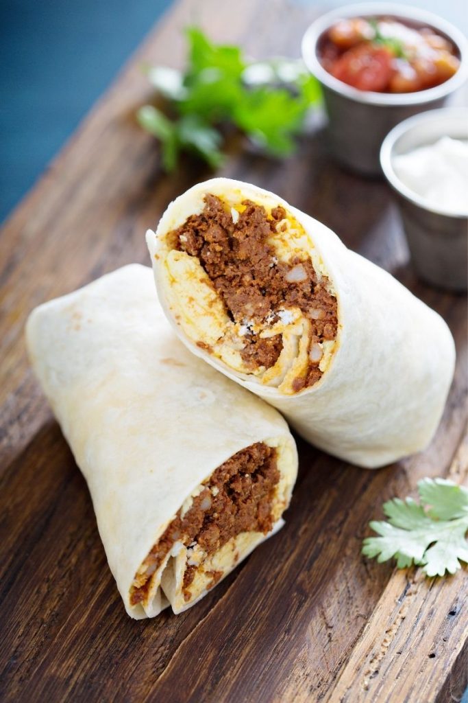 Breafkast burrito on wooden board - breakfast ideas for teens