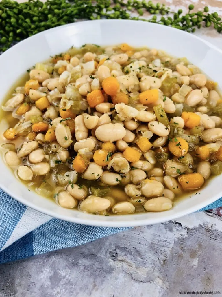 close up view of the finished slow cooker bean soup in a white bowl ready to eat