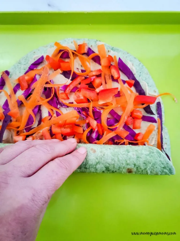 tightly rolling the veggie pinwheels before cutting
