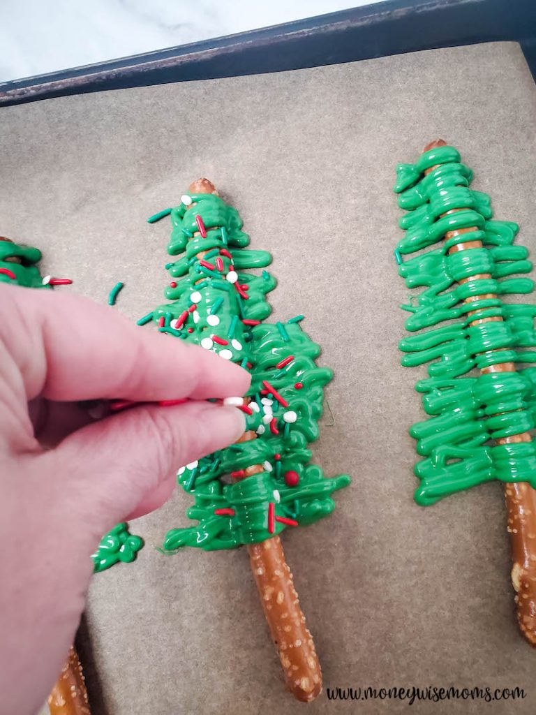 topping the pretzel trees with sprinkles