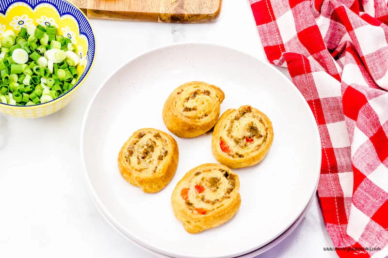 Finished sausage pinwheels with garnish ready to eat.