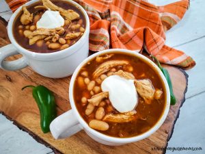 finished slow cooker chicken chili with white beans in bowls ready to eat