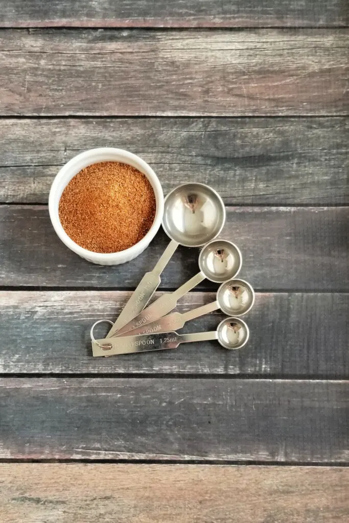 top down finished chili seasoning with measuring spoons. 