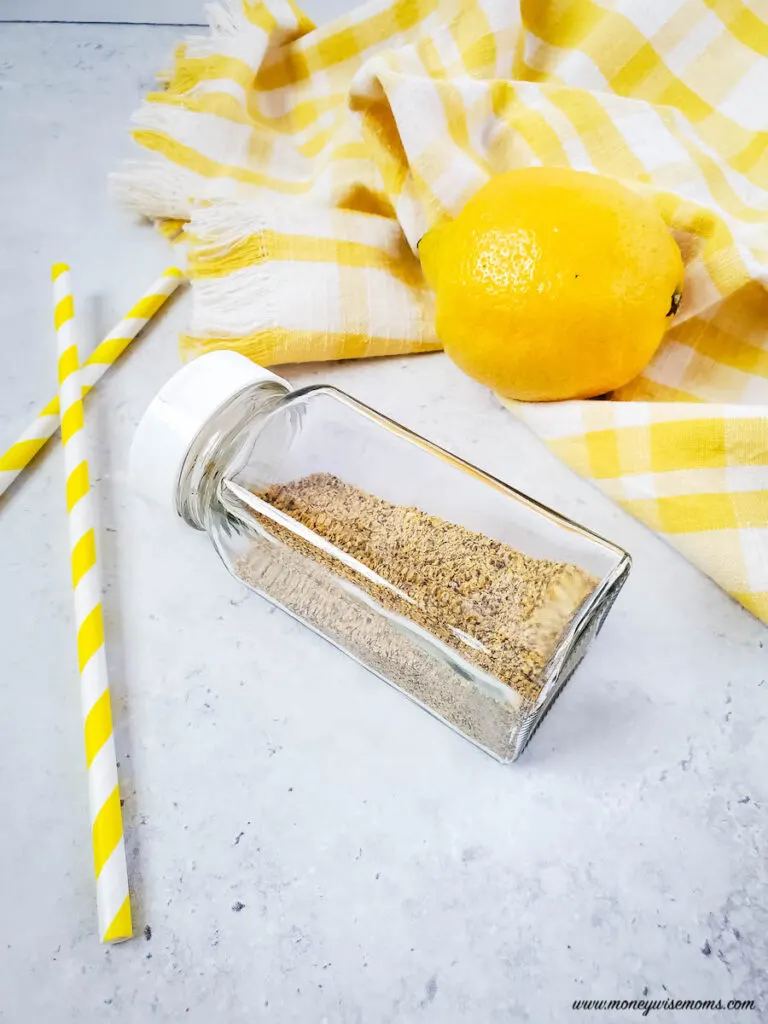 another photo showing finished lemon pepper seasoning with shaker bottle ready to use. 