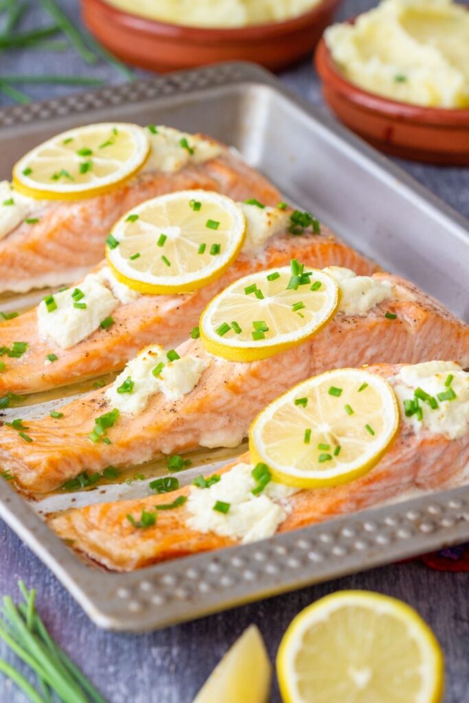 salmon fillets with lemon slices in baking dish