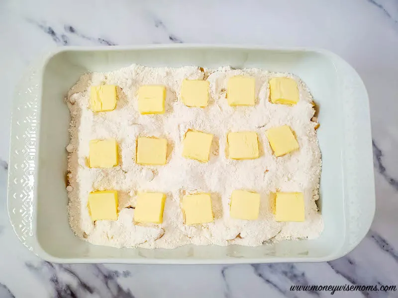 putting butter on top of cake mix