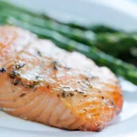 salmon and asparagus on white plate