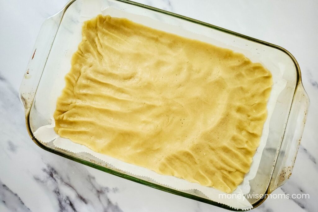 Press raw cookie dough into bottom of baking dish