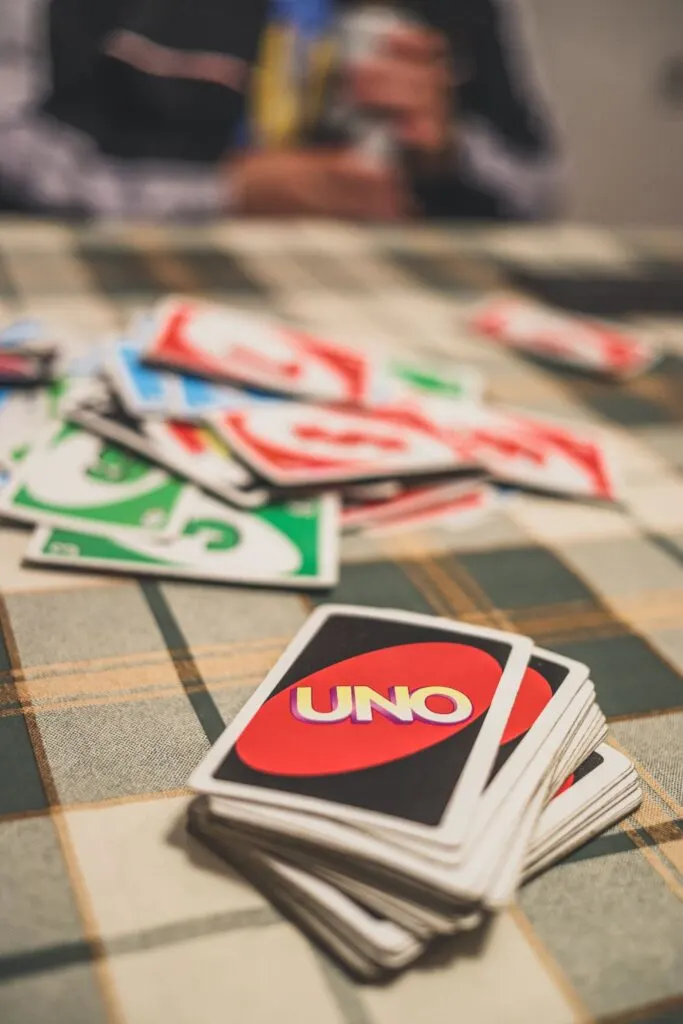 Uno card game playing on table with plaid tablecloth