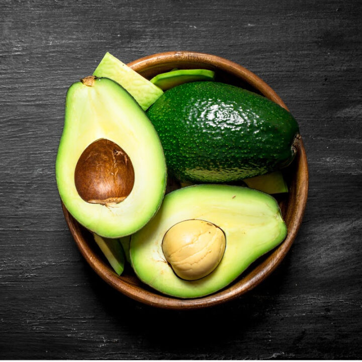 avocados in wooden bowl