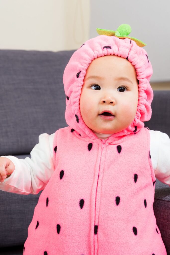 baby in pink strawberry costume