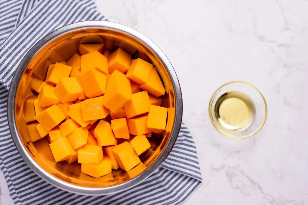 cubed butternut squash in metal bowl