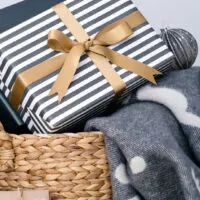 blue and gold striped gift with basket and blanket