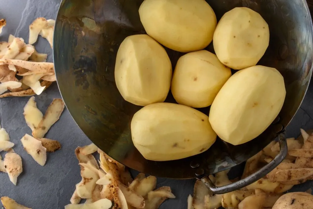 peeled potatoes in bowl