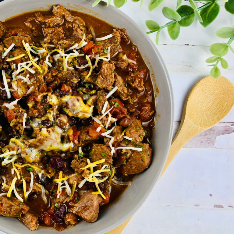 slow cooker southwest chili in bowl with wooden spoon