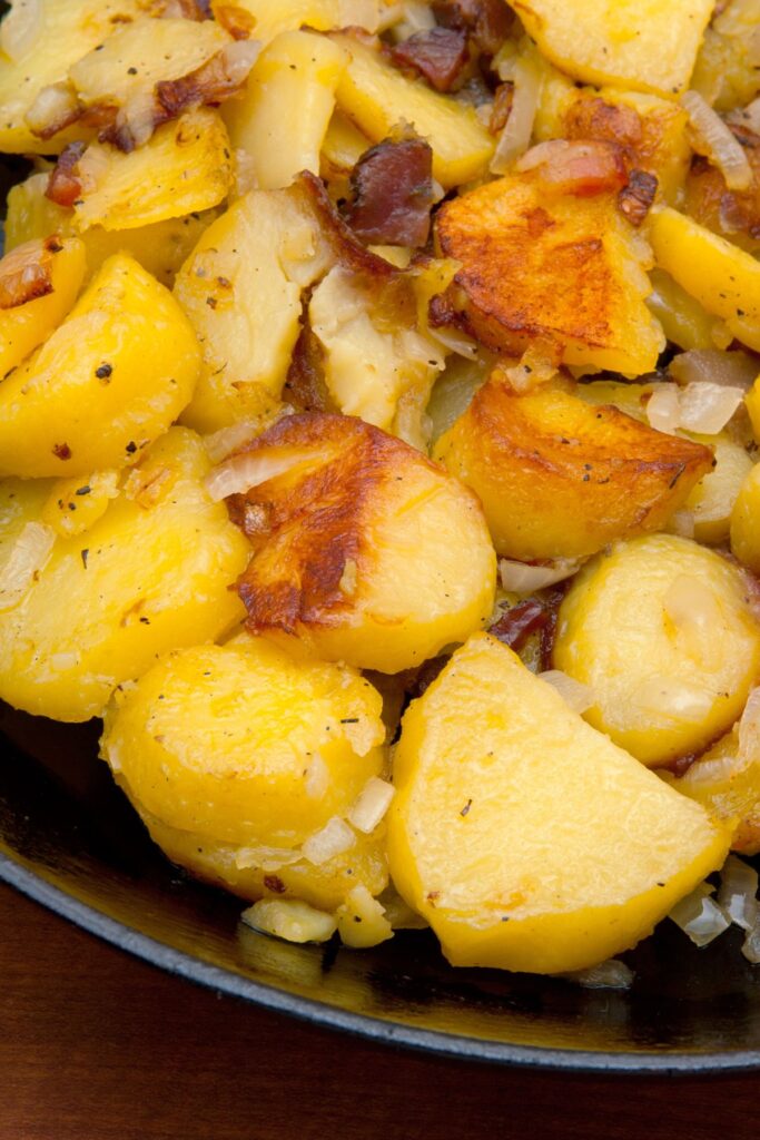 fried potatoes with onions in skillet